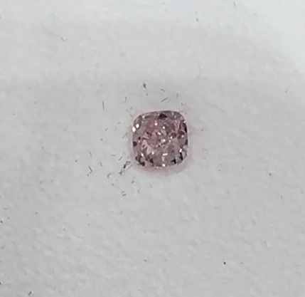 Pink diamond on a light gray background