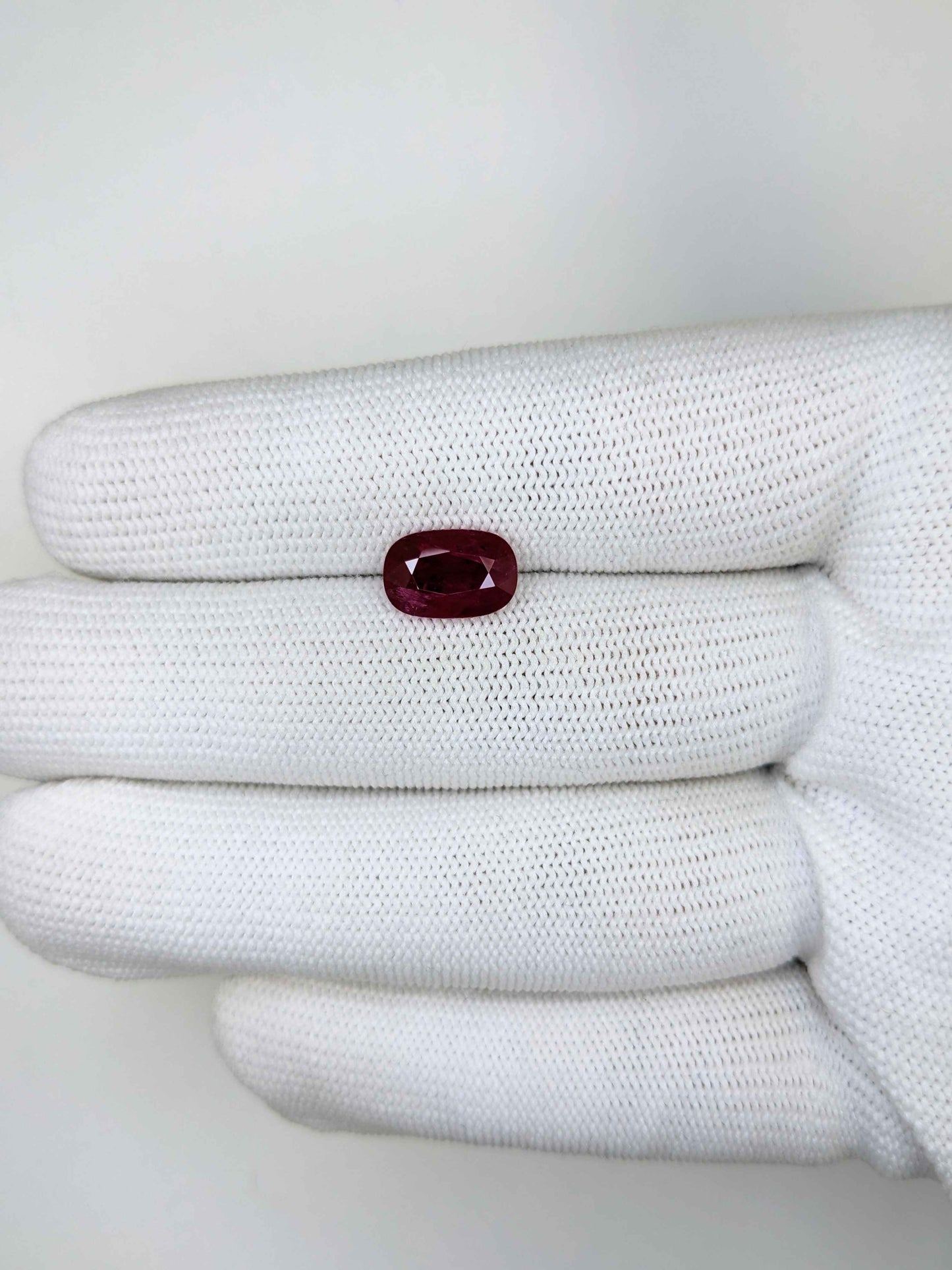 3.11 Carats Oval Cut Heat Red Ruby Loose Gemstone on white glove hand