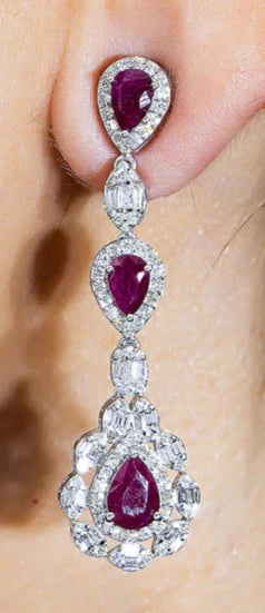 A woman wearing the Baylor Ruby & Diamond Three Tier Drop Earrings