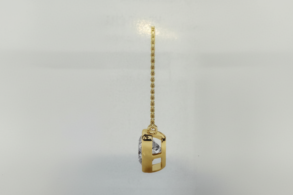 Gold pendant with a chain on a light gray background