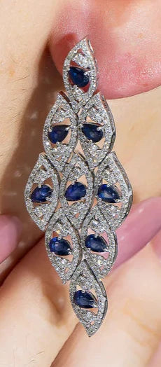 A woman wearing the Johanna Pear Cut Sapphire & diamond Drop Earrings