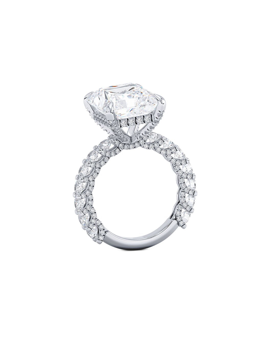 Diamond ring with a large central princess cut diamond and smaller stones on a white background