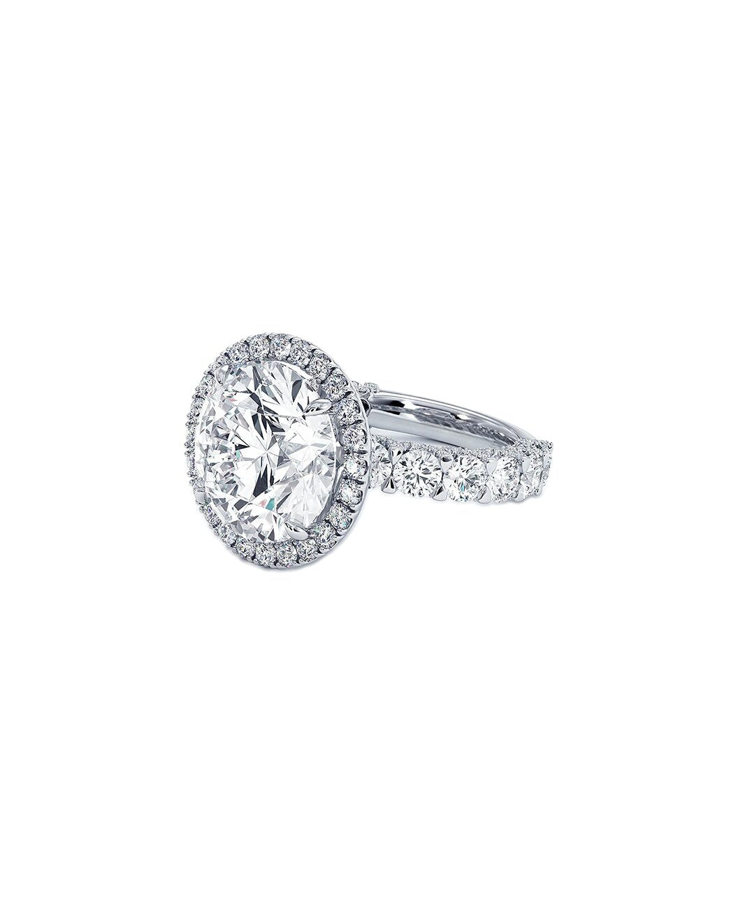 Diamond ring with a halo setting on a white background