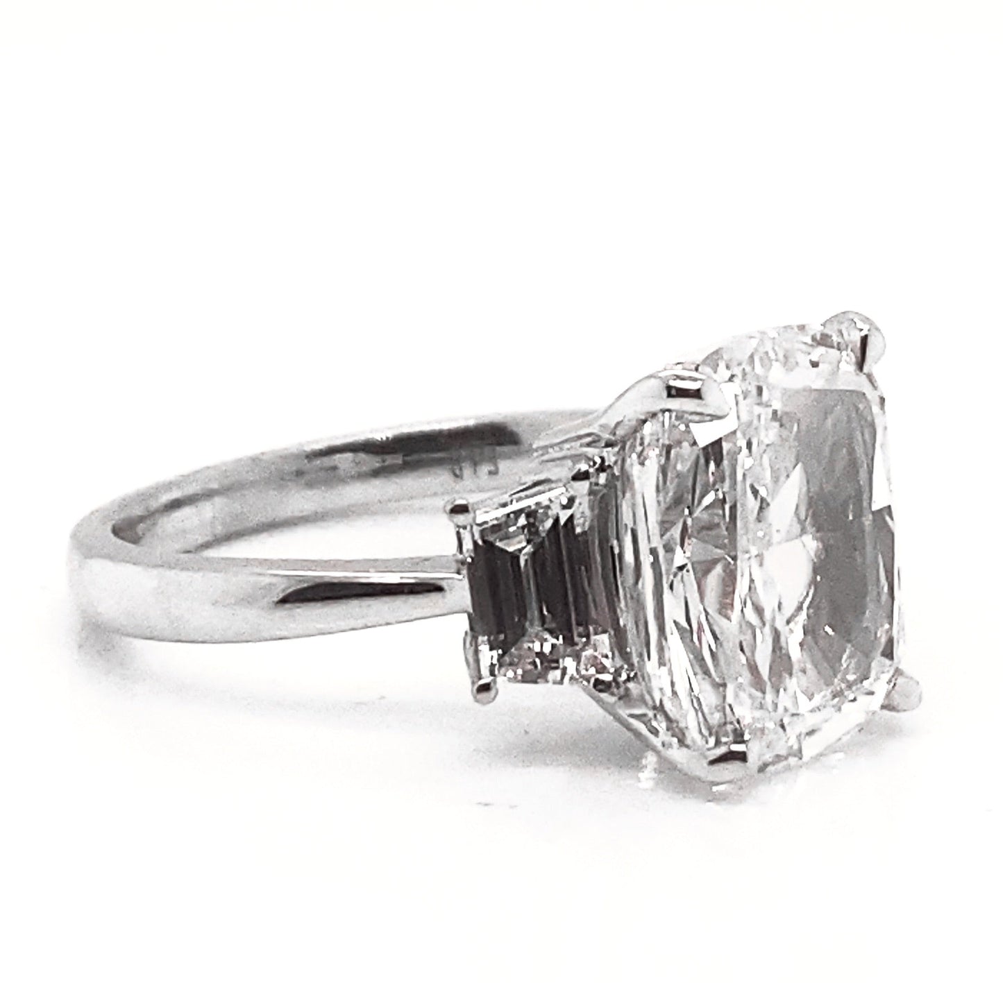 Nekta New York three stone cushion cut ring with sparkling side diamonds on silver band