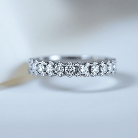Close-up of a sparkling diamond eternity ring with diamonds encircling the band, set against a soft background highlighting its brilliance and craftsmanship.