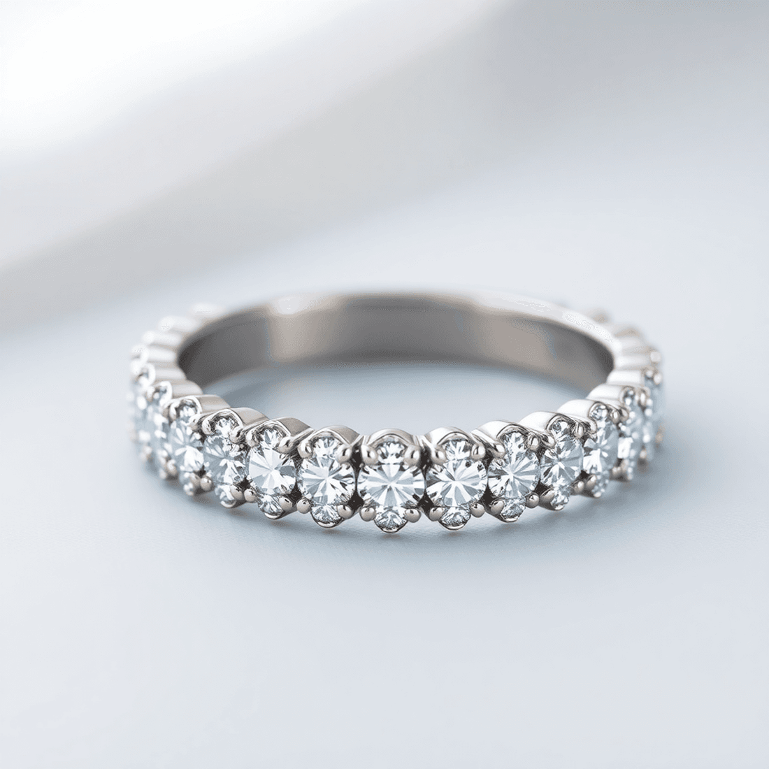 Close-up of a sparkling diamond eternity ring with continuous diamonds on a soft, reflective background symbolizing infinite love and timeless commitment.