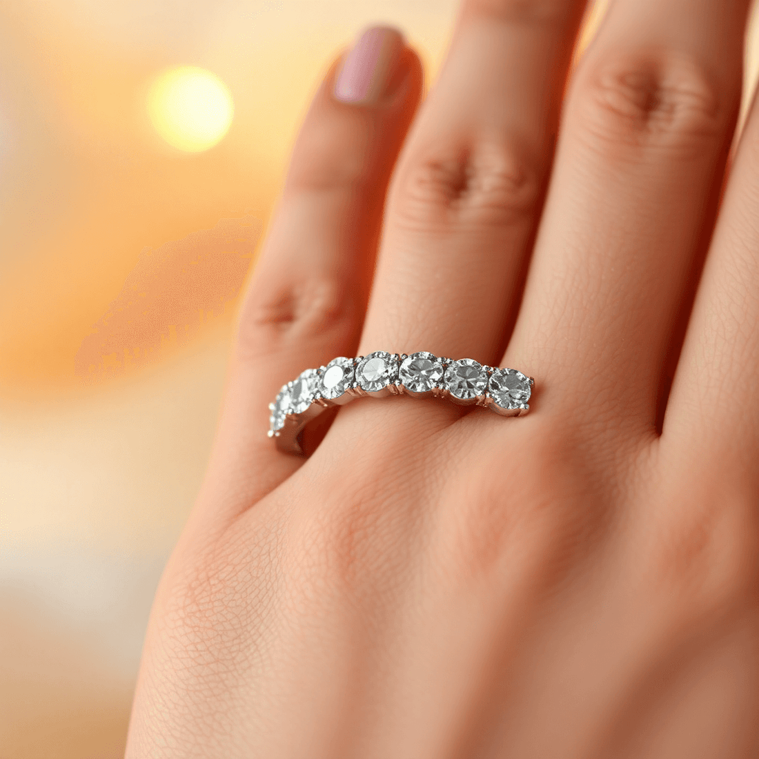 Close-up of a sparkling diamond eternity band on a hand, glowing softly with warm, romantic lighting highlighting the continuous circle of diamonds.