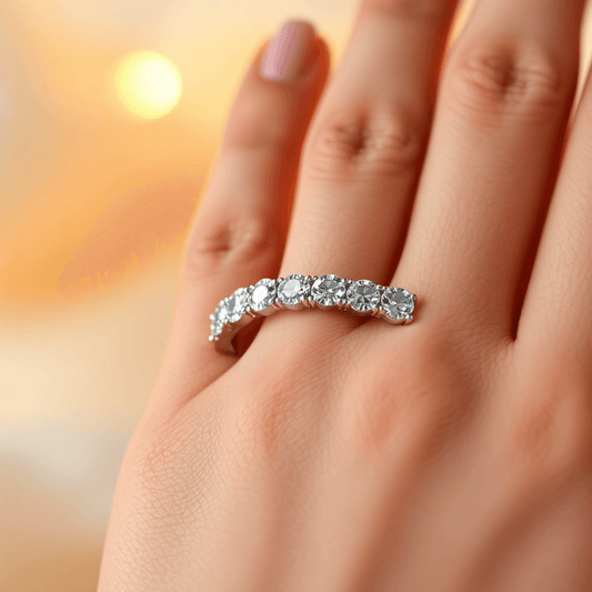 Close-up of a sparkling diamond eternity band on a hand, glowing softly with warm, romantic lighting highlighting the continuous circle of diamonds.