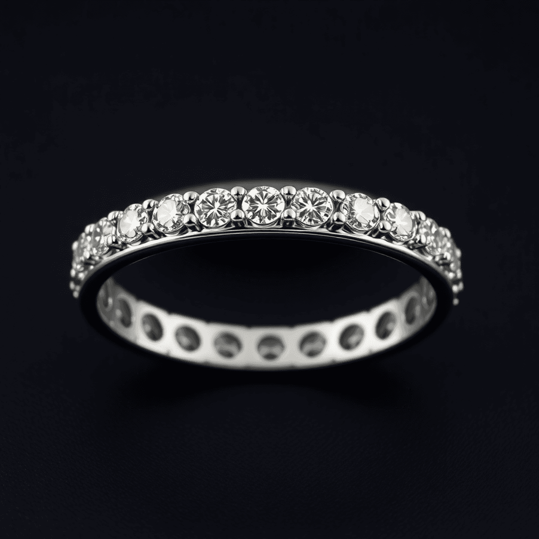 Close-up of a men's diamond eternity band with precision-cut diamonds on a sleek metal setting against a dark elegant background.