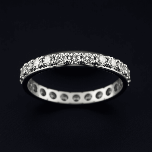 Close-up of a men's diamond eternity band with precision-cut diamonds on a sleek metal setting against a dark elegant background.