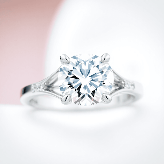 Close-up of an elegant diamond ring with a split shank band, highlighting the open design and sparkling diamond against a soft, blurred background.