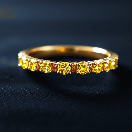 Close-up of a gold eternity band with vibrant yellow diamonds glowing softly on a dark velvet background, showcasing elegance and luxury.