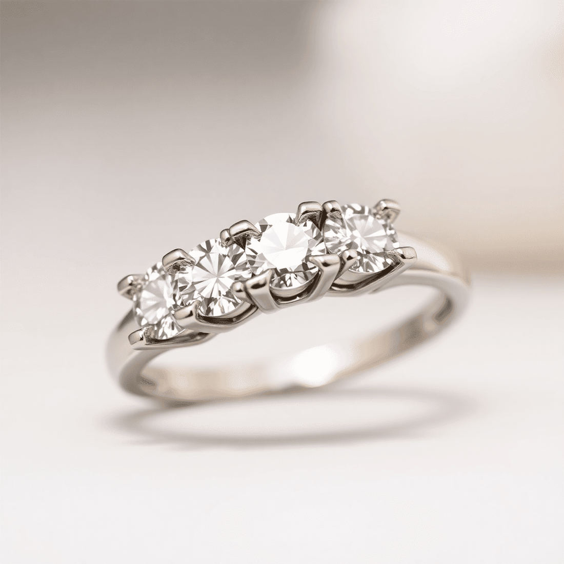 Close-up of an elegant diamond ring with sparkling gemstones held by delicate prongs, highlighting the brilliance and craftsmanship against a blurred background