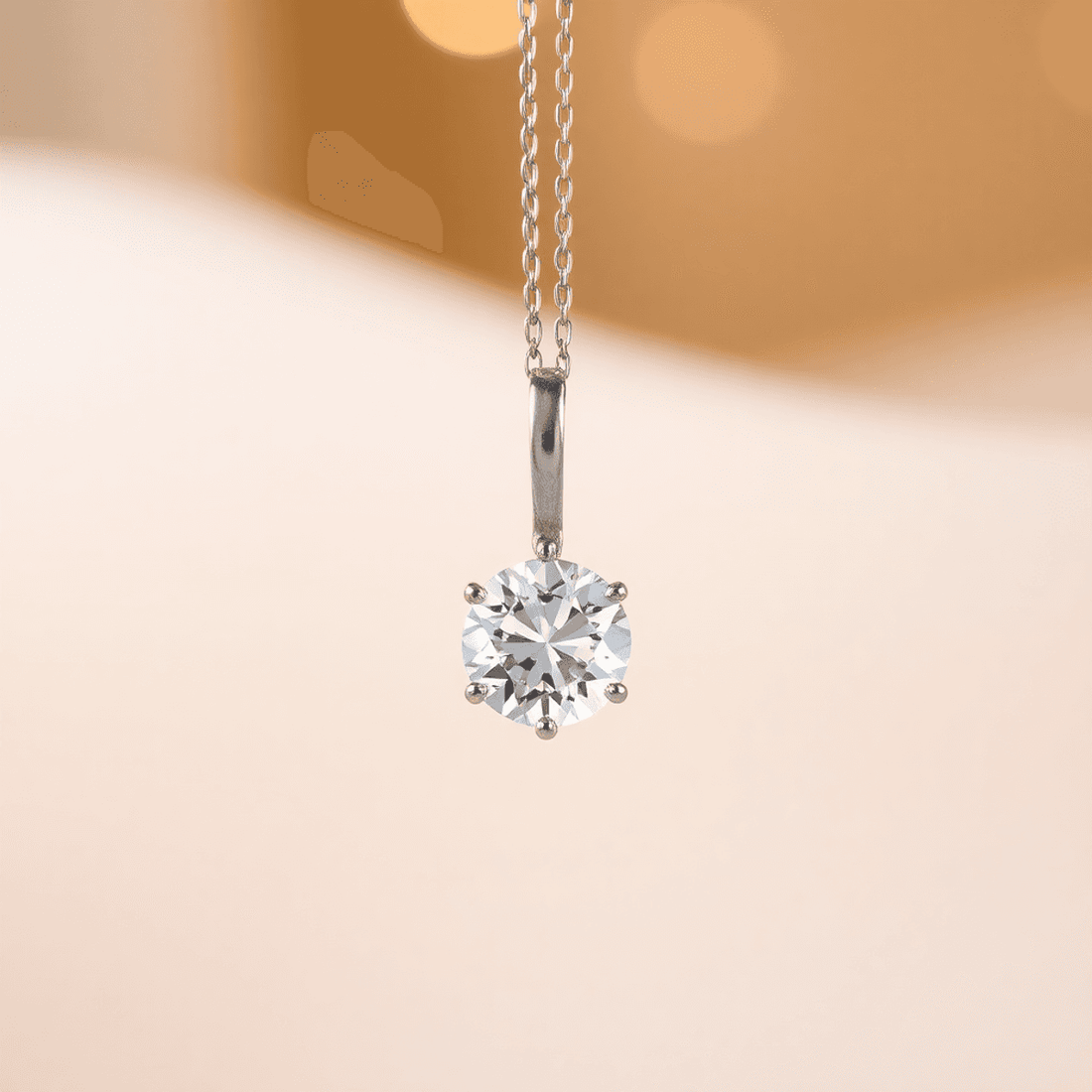 Close-up of a sparkling diamond pendant on a fine chain against a soft, warm background highlighting the diamond's brilliance and elegance.