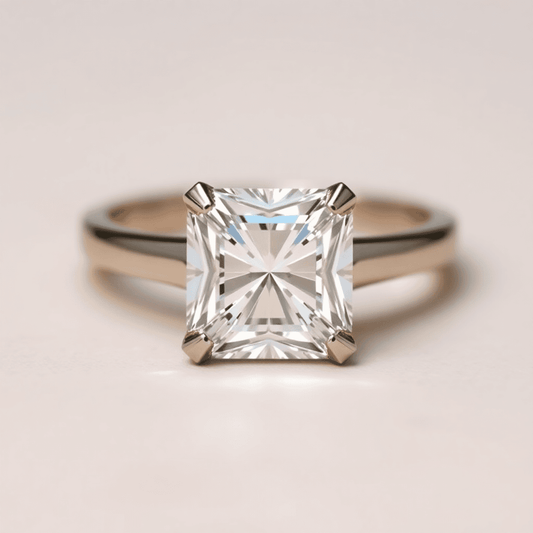 Close-up of an elegant radiant cut diamond ring with sparkling facets and beveled corners on a soft neutral background.