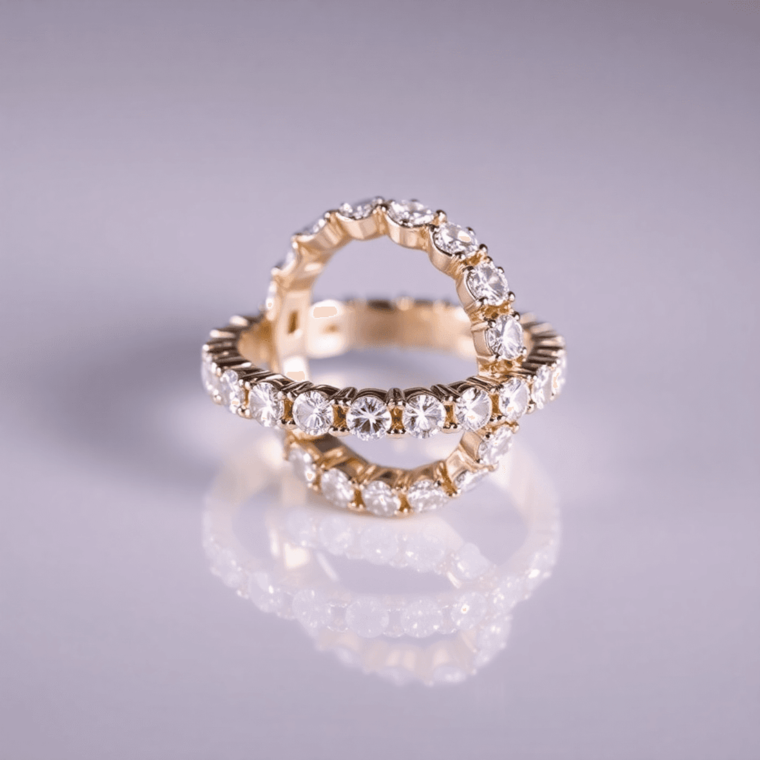 Close-up of a sparkling diamond eternity band on a reflective surface, illuminated by soft lighting that highlights the diamonds' brilliance and clarity.