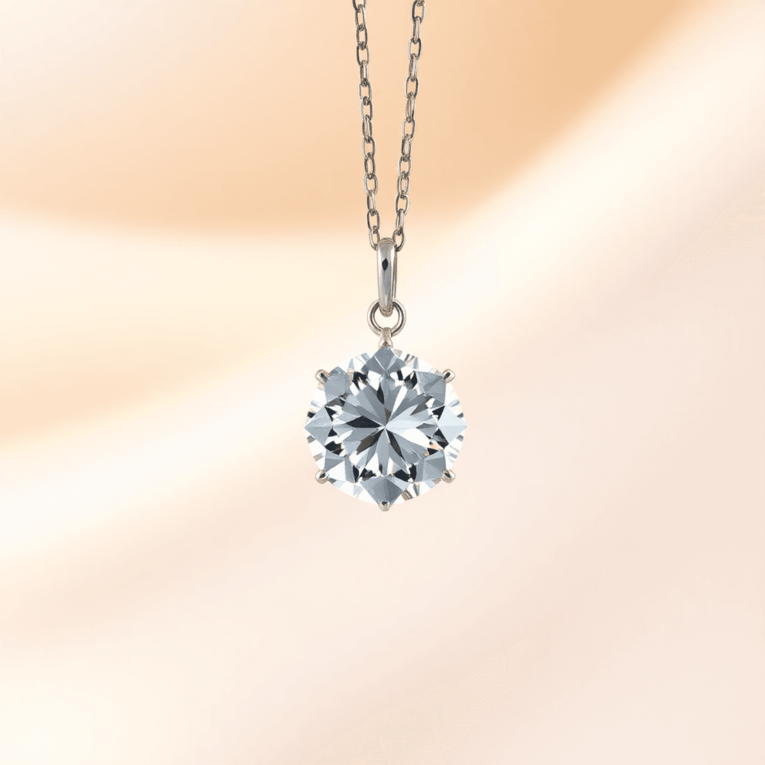 Close-up of a sparkling diamond pendant on a fine chain against a soft, elegant background with gentle lighting highlighting its brilliance and facets.