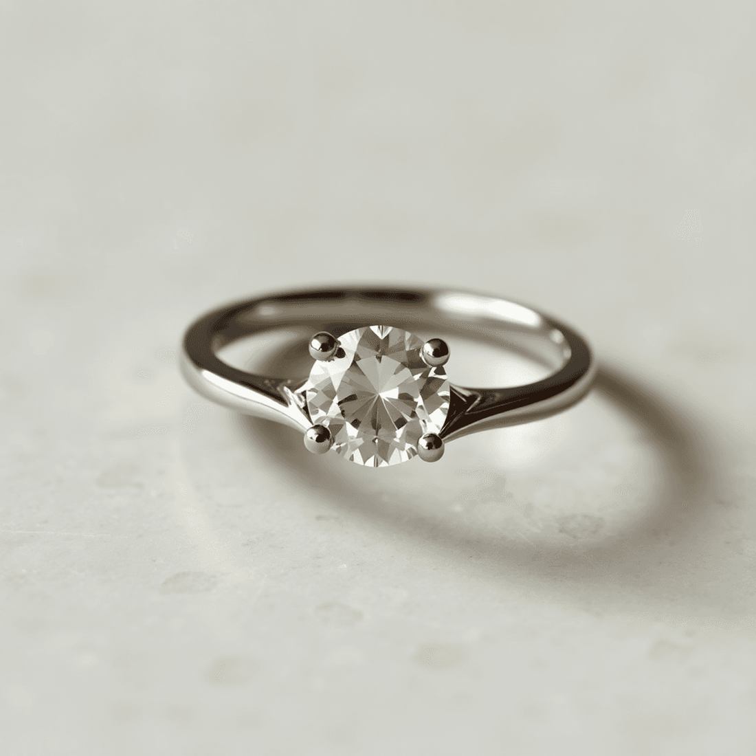 Close-up of an elegant split shank ring with two distinct bands near the center stone, showcasing detailed craftsmanship and sparkling metal and gemstone.