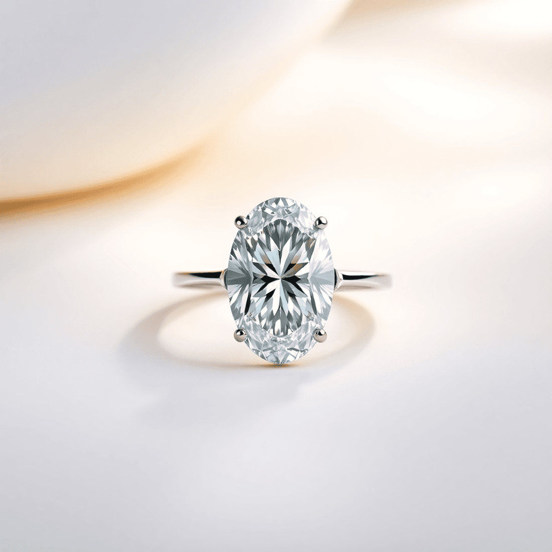 Close-up of a sparkling oval cut diamond ring on a soft background with gentle light reflections highlighting its brilliance and elegant shape.