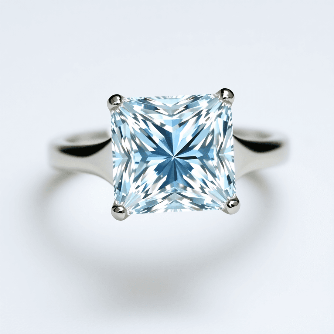 Close-up of a sparkling princess cut diamond ring with a modern design on a soft, neutral background.