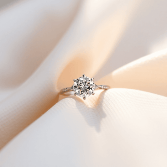 Close-up of a sparkling engagement ring on soft fabric, illuminated by natural light highlighting its intricate details and brilliance.