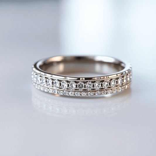 Close-up of a men's diamond eternity band ring on a smooth surface with soft warm lighting highlighting its continuous circle.