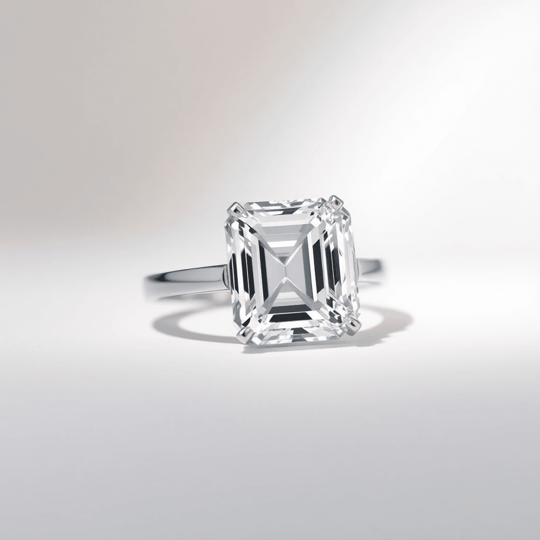 Close-up of a sparkling baguette cut diamond ring with clean rectangular facets on a soft neutral background, highlighting its clarity and internal structure.
