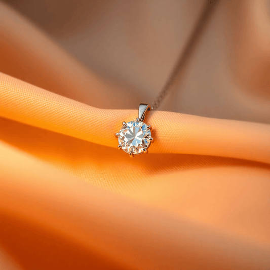 Close-up of a sparkling diamond pendant on soft fabric with warm lighting highlighting its brilliance and elegance.