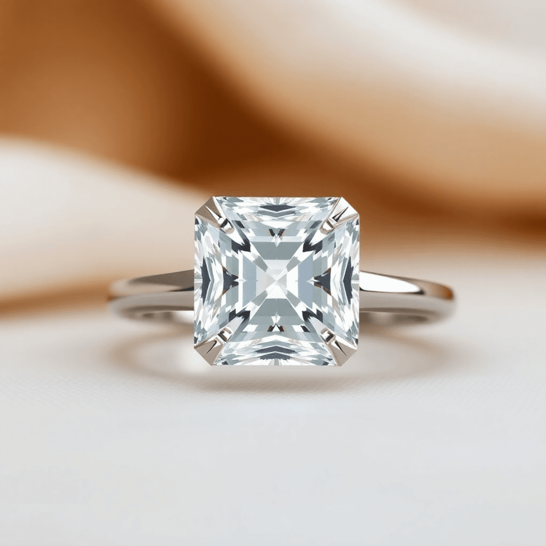Close-up of a sparkling Asscher cut diamond ring showcasing its square shape and step-cut facets against a soft, elegant background.