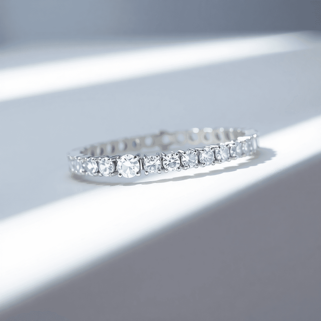 Close-up of a sparkling lab-grown diamond tennis bracelet on a white background with soft natural lighting highlighting its brilliance and elegant design.