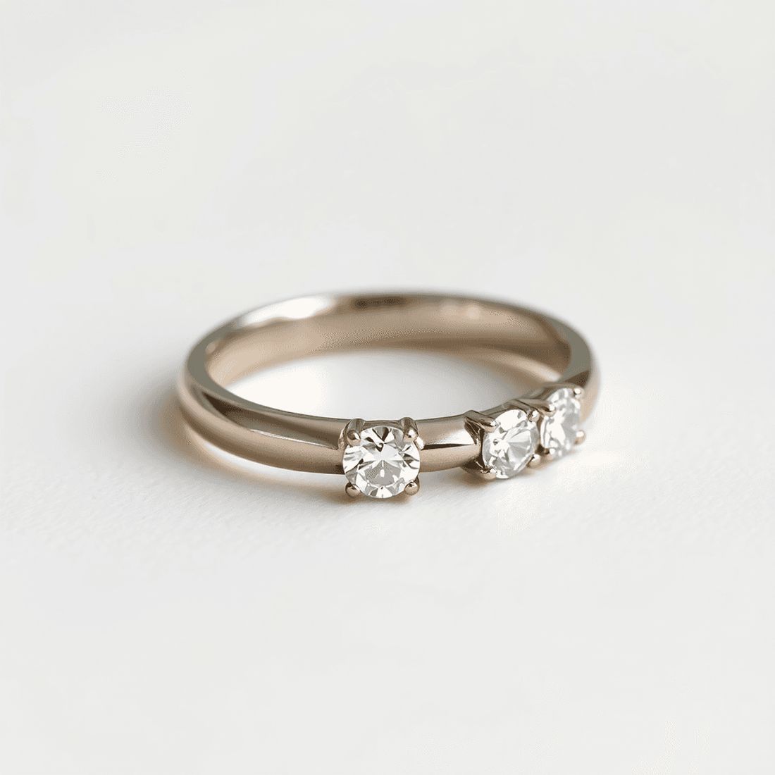 Close-up of an elegant lab-grown diamond ring with side stones on a polished metal band, set against a soft neutral background with gentle lighting.