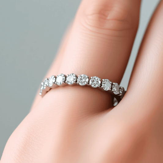 Close-up of a sparkling diamond eternity band on a finger, highlighting the continuous circle of diamonds with soft lighting against a blurred background.