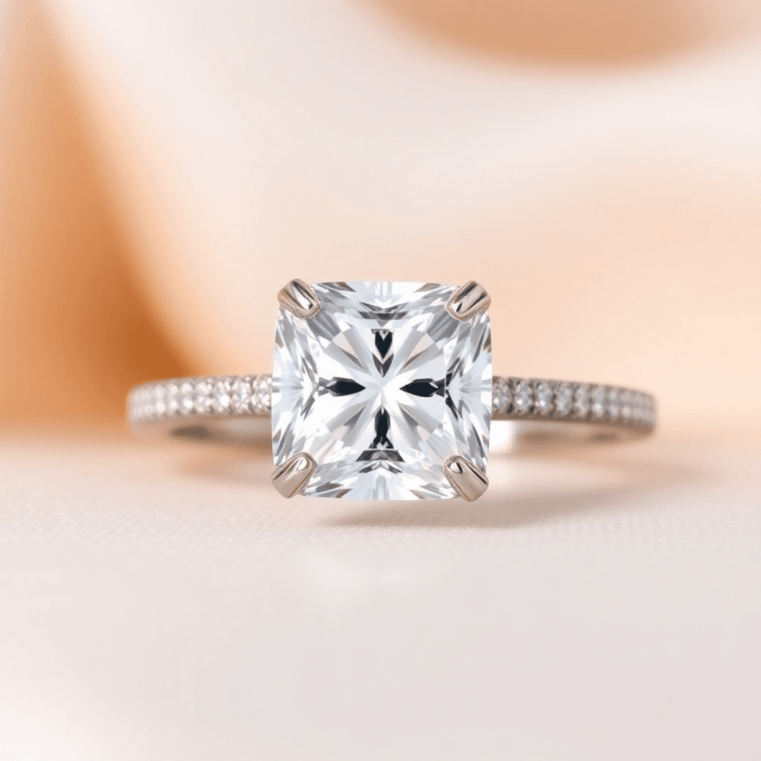 Close-up of a sparkling cushion cut diamond engagement ring with a hidden halo on a soft, elegant background highlighting its brilliance and timeless design.