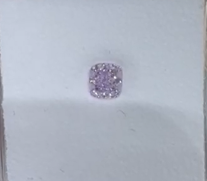 Purple diamond in a light blue box on a white background