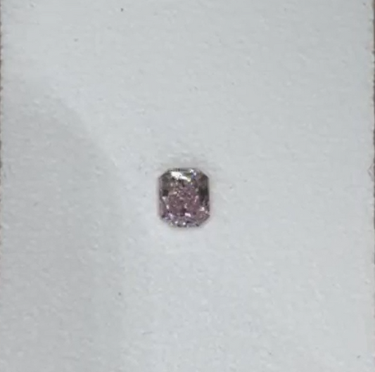 Fancy Intense Purplish Pink loose diamond on a white background