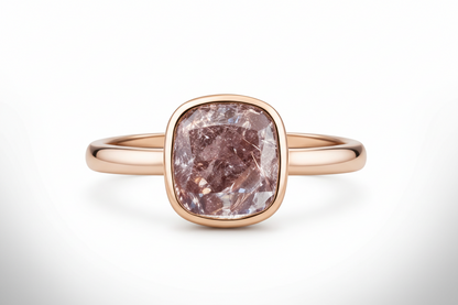 Rose gold ring with a large,cushion-cut diamond on a white background