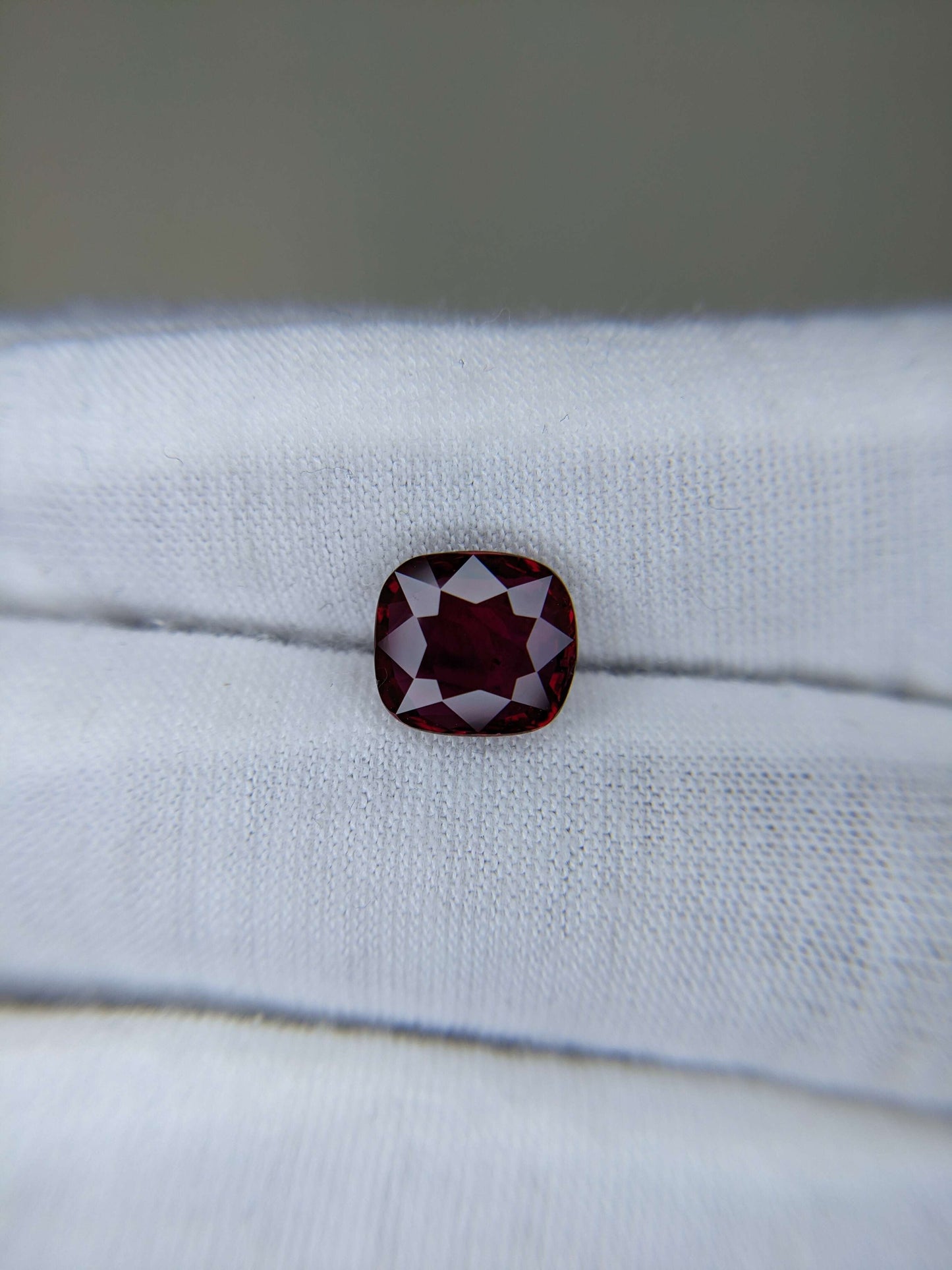 Red gemstone on a white cloth background