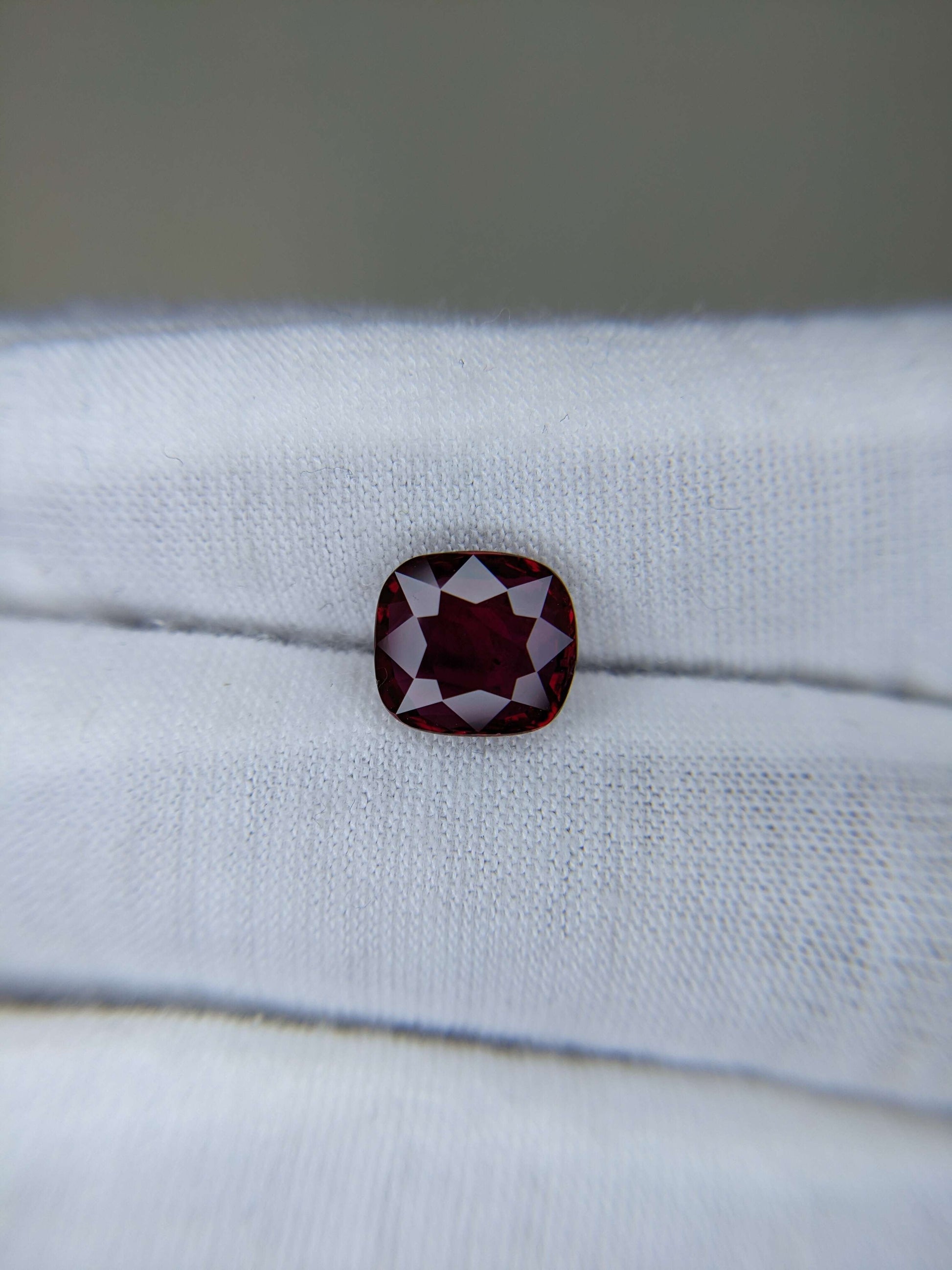 Red gemstone on a white cloth background
