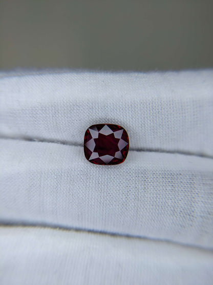 Red gemstone on a white cloth background