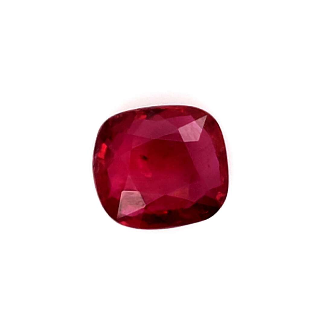 Cushion-shaped red gemstone on a white background