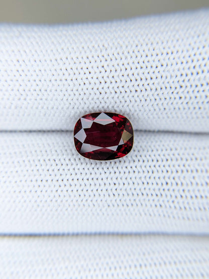 Red ruby gemstone on a white fabric background