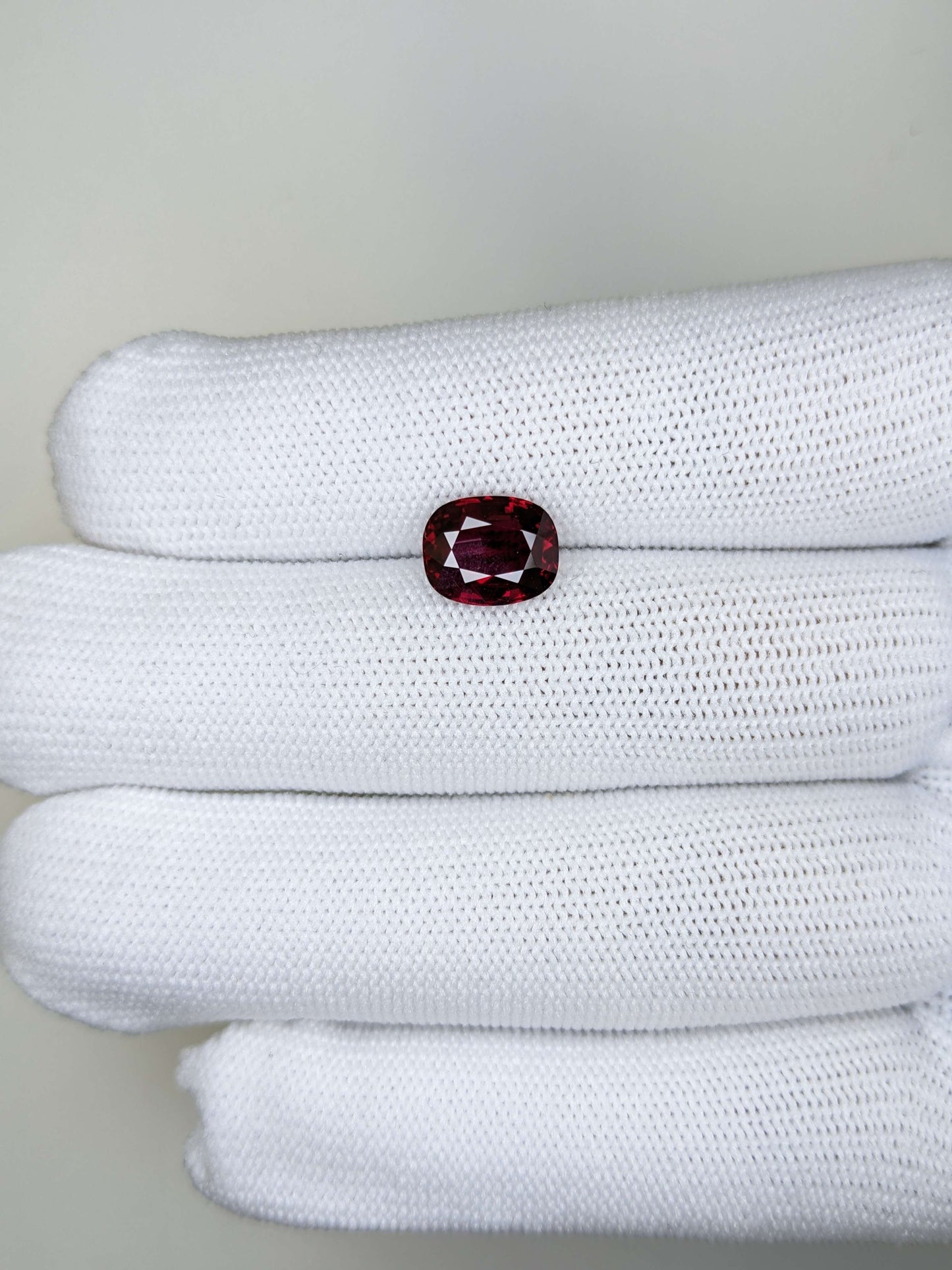 Red ruby gemstone on a fabric background