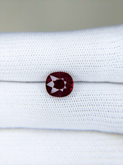 Red gemstone on a white gloves