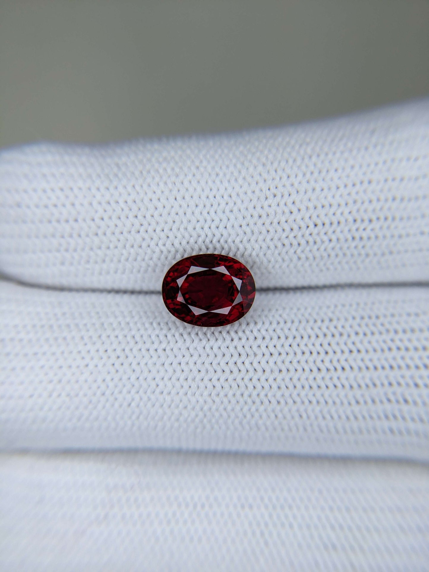 Red gemstone on a white cloth background
