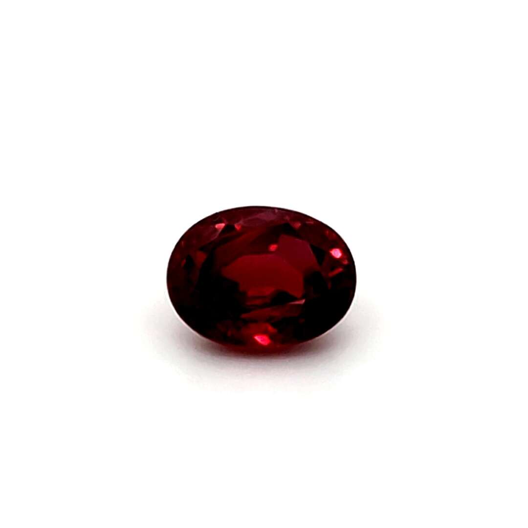 Oval red ruby gemstone on a white background