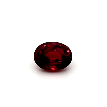 Oval red ruby gemstone on a white background