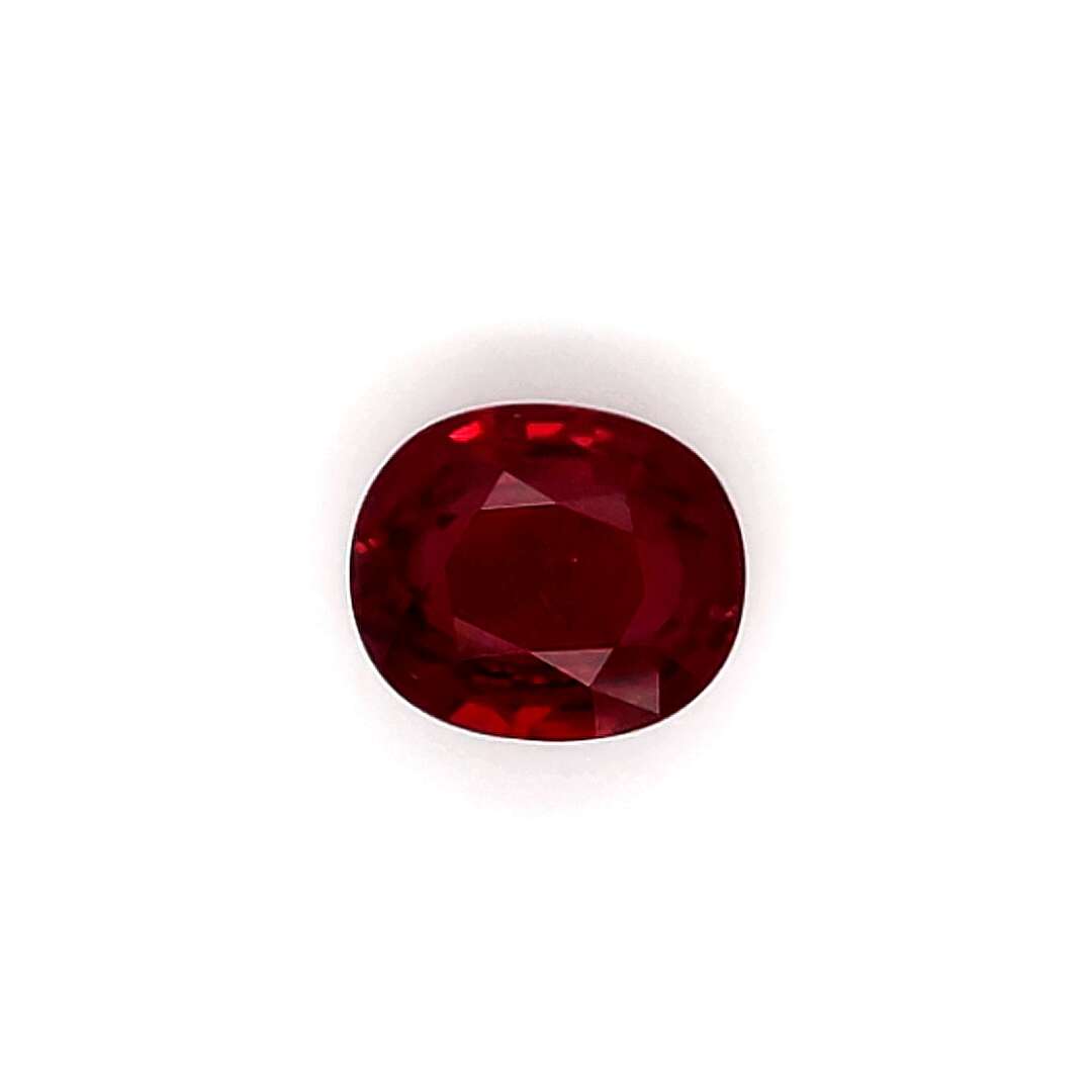Round red ruby gemstone on a white background