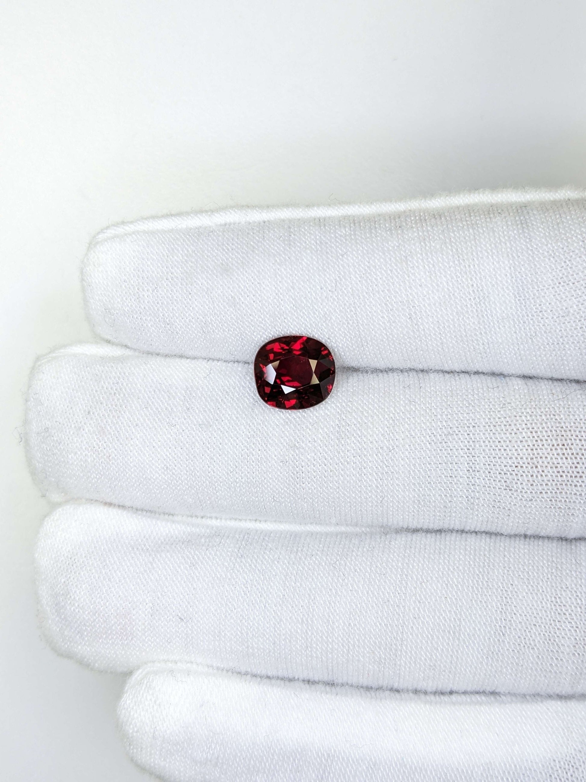 cushion red ruby loose gemstone on a white background