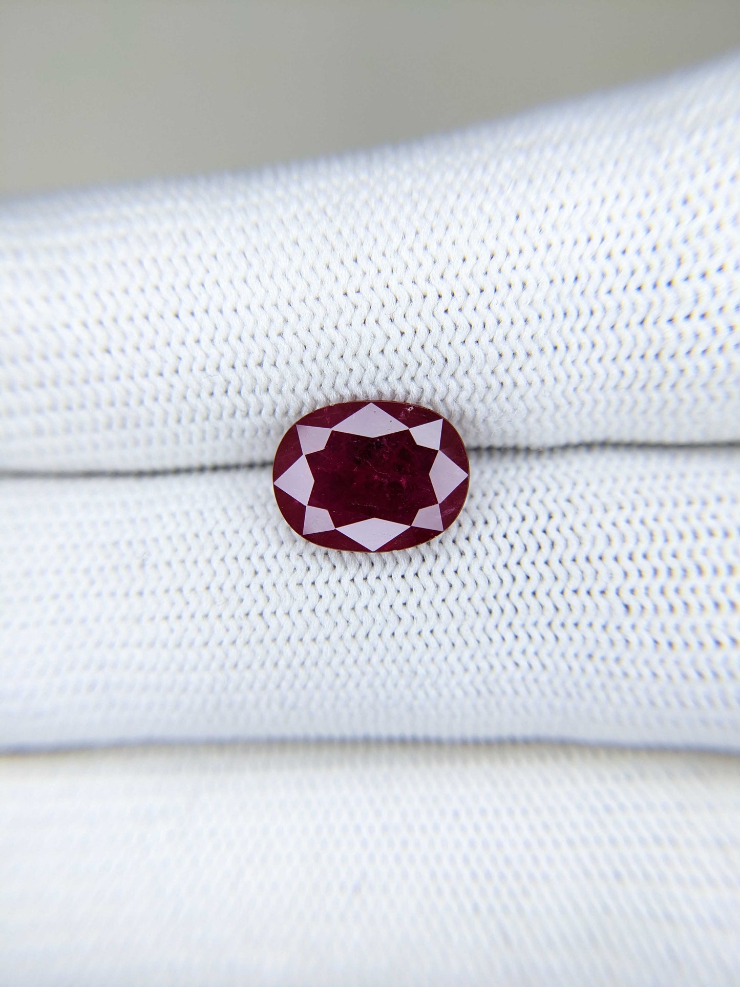 3.39 Carats Oval Cut Heat Red Ruby Loose Gemstone On Hand Closeup