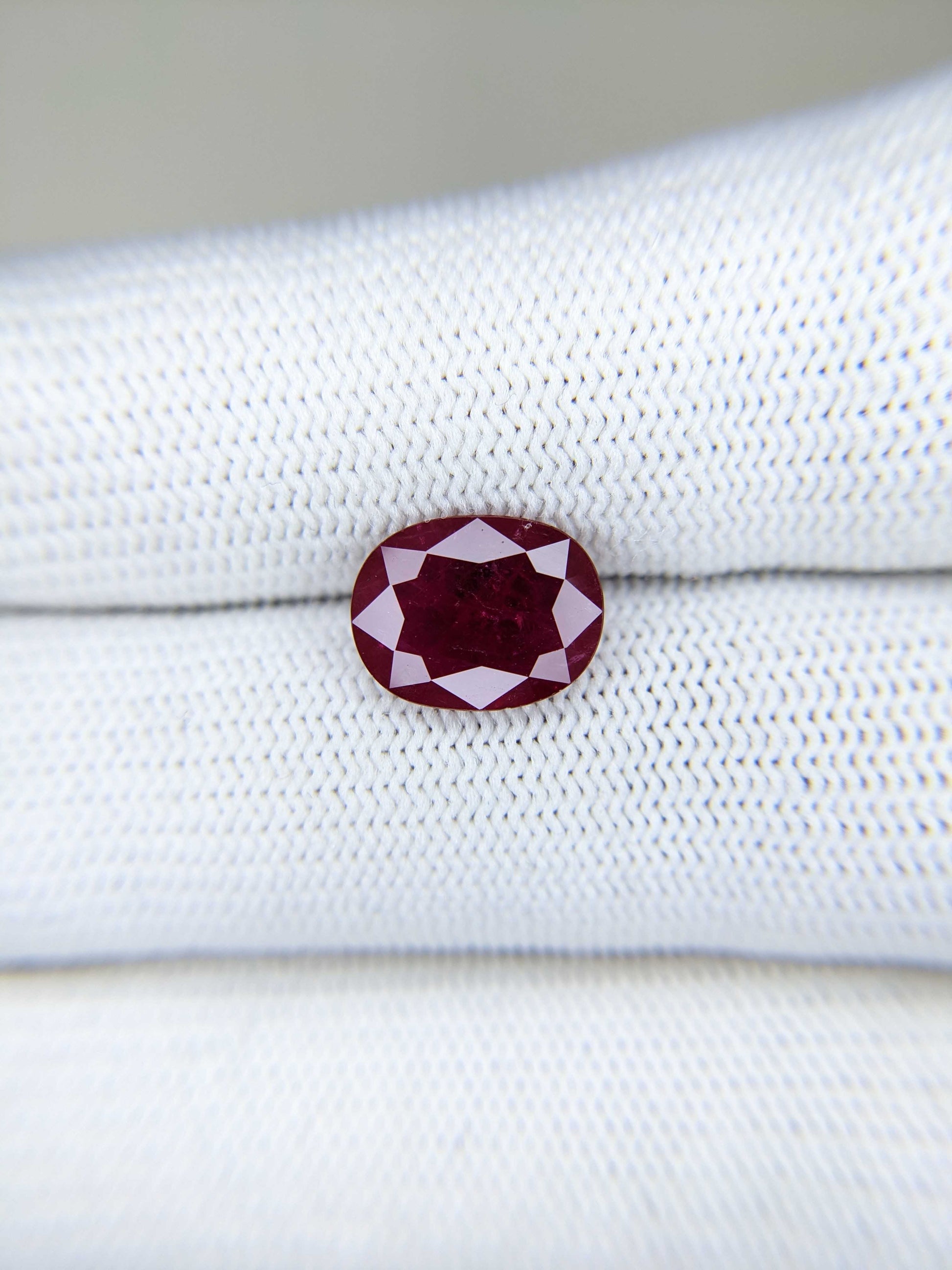 3.39 Carats Oval Cut Heat Red Ruby Loose Gemstone On Hand Closeup